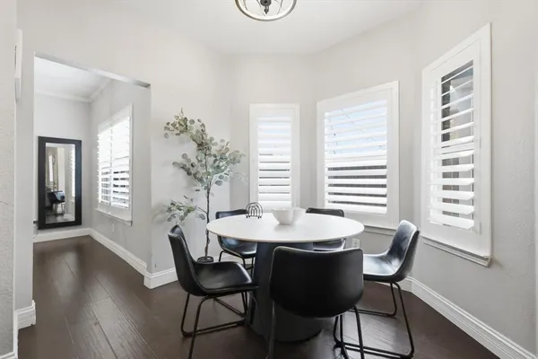 a dining room with furniture and wooden floor