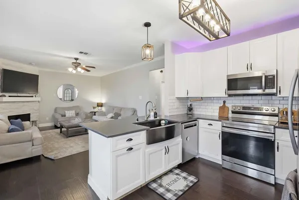 a kitchen with a sink stove and microwave