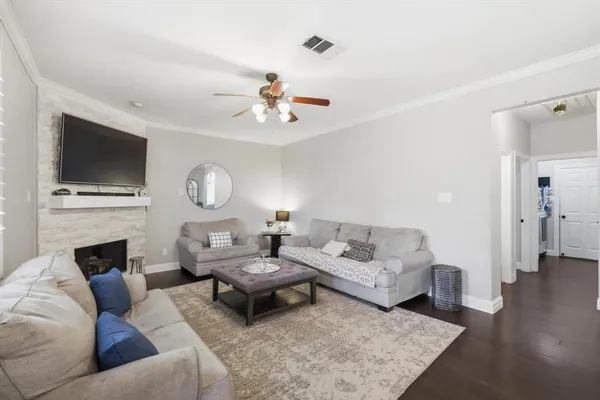 a living room with furniture flat screen tv and a fireplace