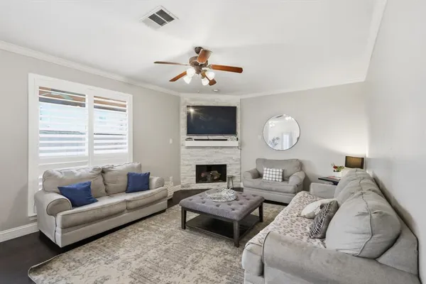 a living room with furniture a fireplace and a window