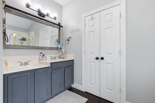 a bathroom with a sink vanity and a mirror