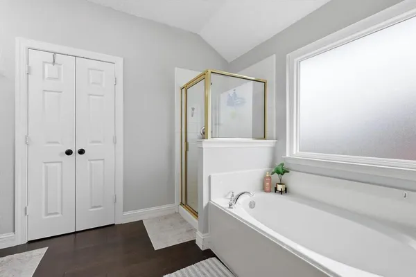 a bathroom with a bathtub and shower