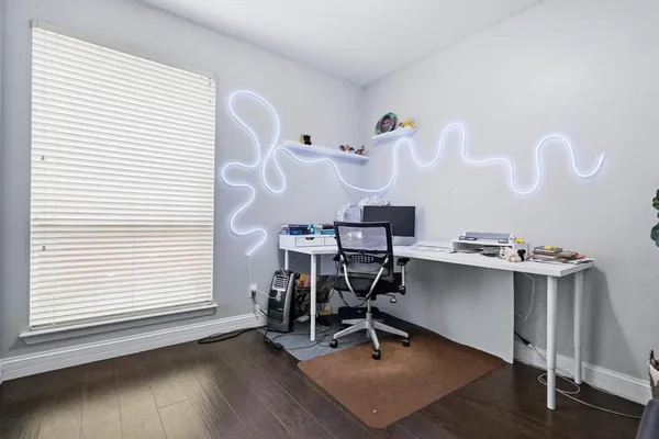 a view of a workspace with furniture and a window