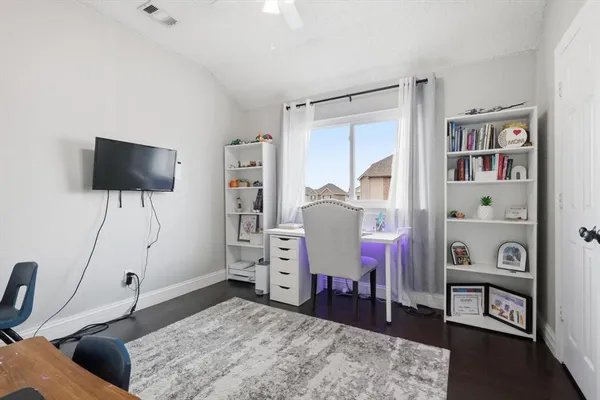 a living room with furniture a flat screen tv and a table