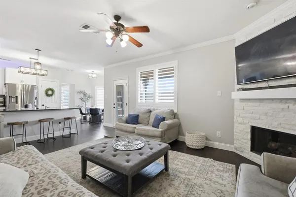 a living room with furniture a flat screen tv and a fireplace