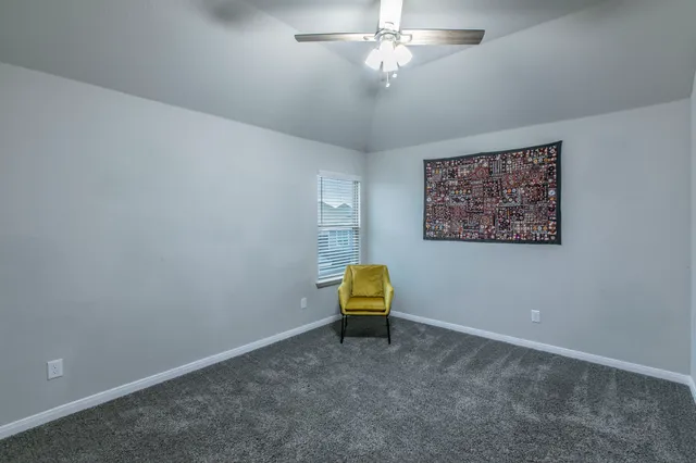 a view of room with ceiling fan and window