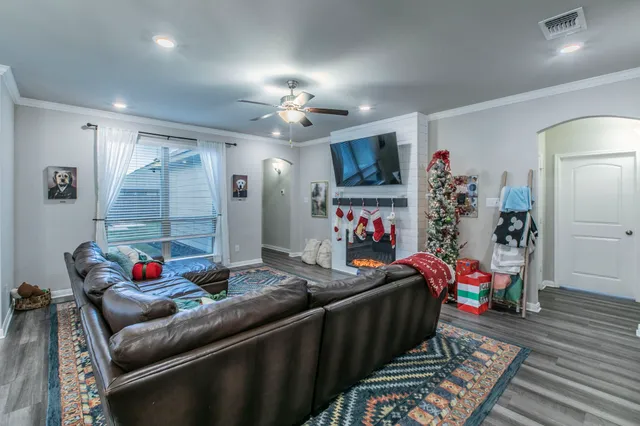 a living room with furniture and a chandelier