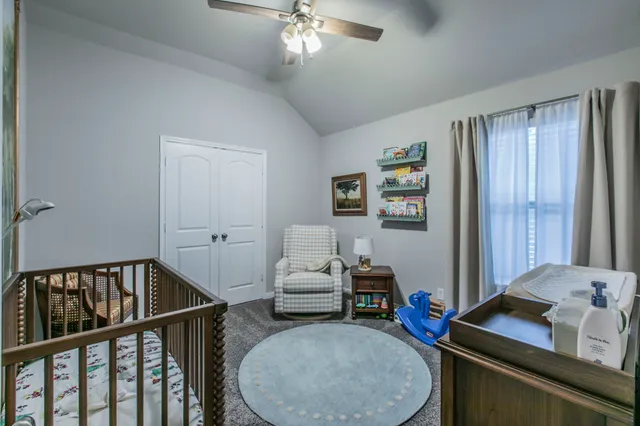 a bedroom with furniture and a window