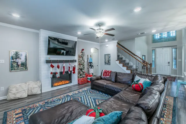 a living room with furniture and a flat screen tv