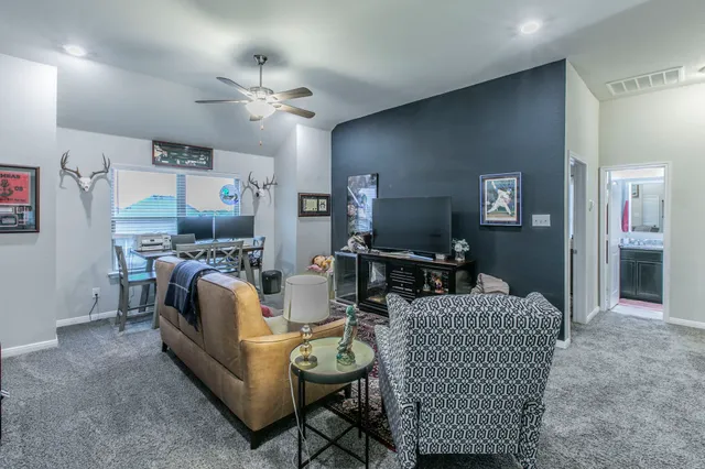 a living room with furniture and a chandelier
