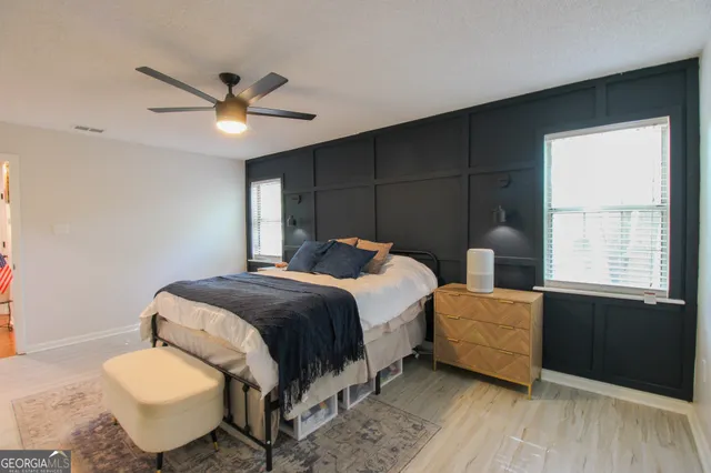 a bedroom with a bed and a window