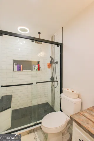 a white toilet sitting next to a bathroom sink