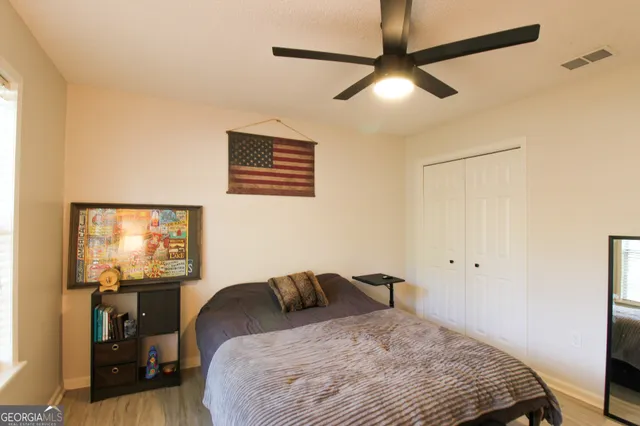 a bedroom with a bed and a chandelier