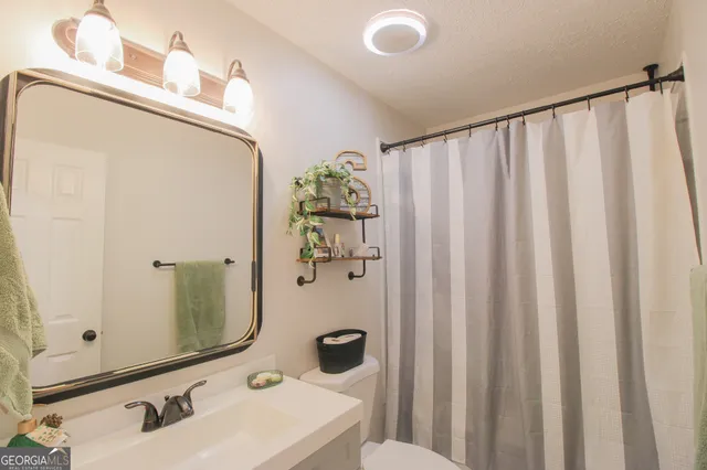 a bathroom with a sink and mirror