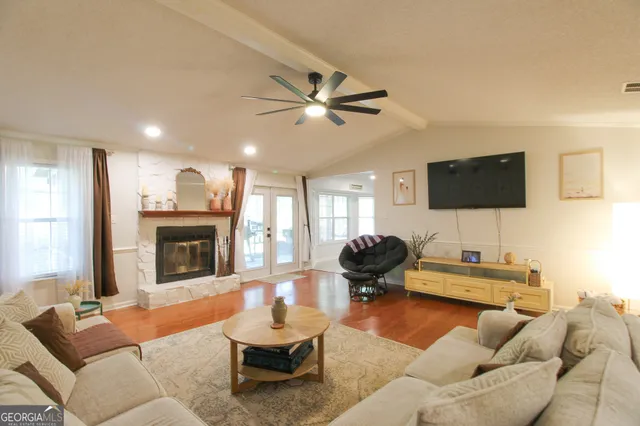 a living room with furniture and a flat screen tv