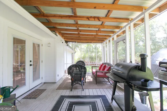 a living room with furniture a wooden floor and a large window