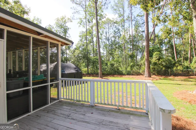 a view of a wooden deck and a yard