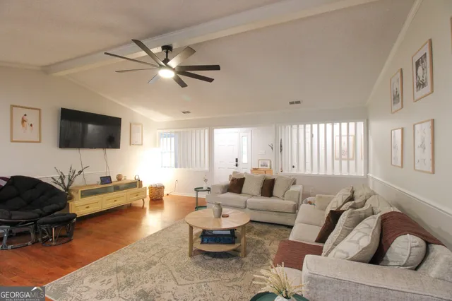 a living room with furniture and a flat screen tv