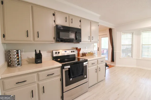 a kitchen with stainless steel appliances white cabinets and a sink