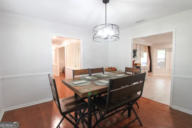 a view of a dining room with furniture wooden floor and chandelier