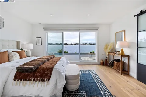 a bed room with a bed and a large window