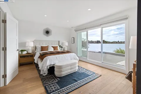 a bed sitting in a bedroom next to a window