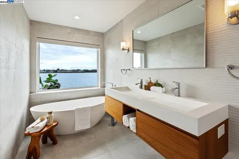 a bathroom with a sink mirror and a bathtub
