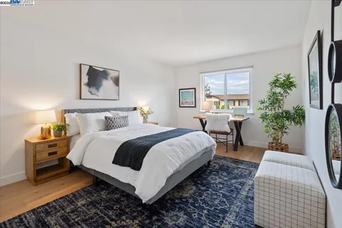 a bedroom with bed and a potted plant