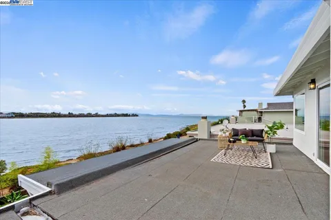 a terrace with outdoor seating and city view
