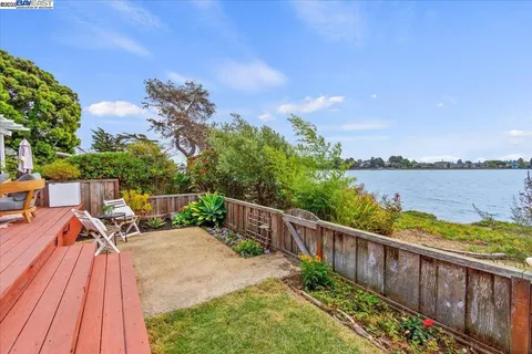 a view of balcony with wooden floor and fence