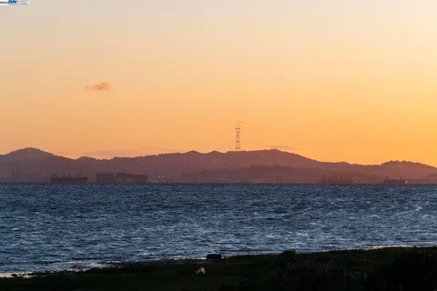 a view of a large mountain with mountains in the background