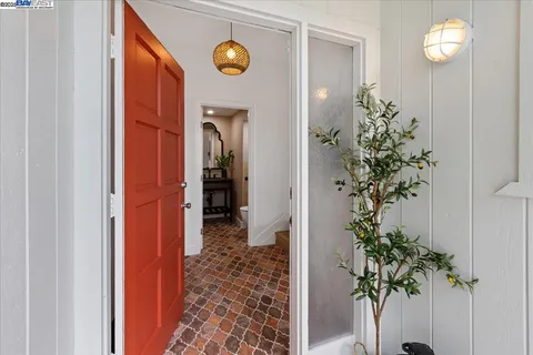 a view of a hallway to a livingroom with a potted plant