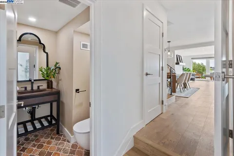 a view of a hallway with dining area and glass door