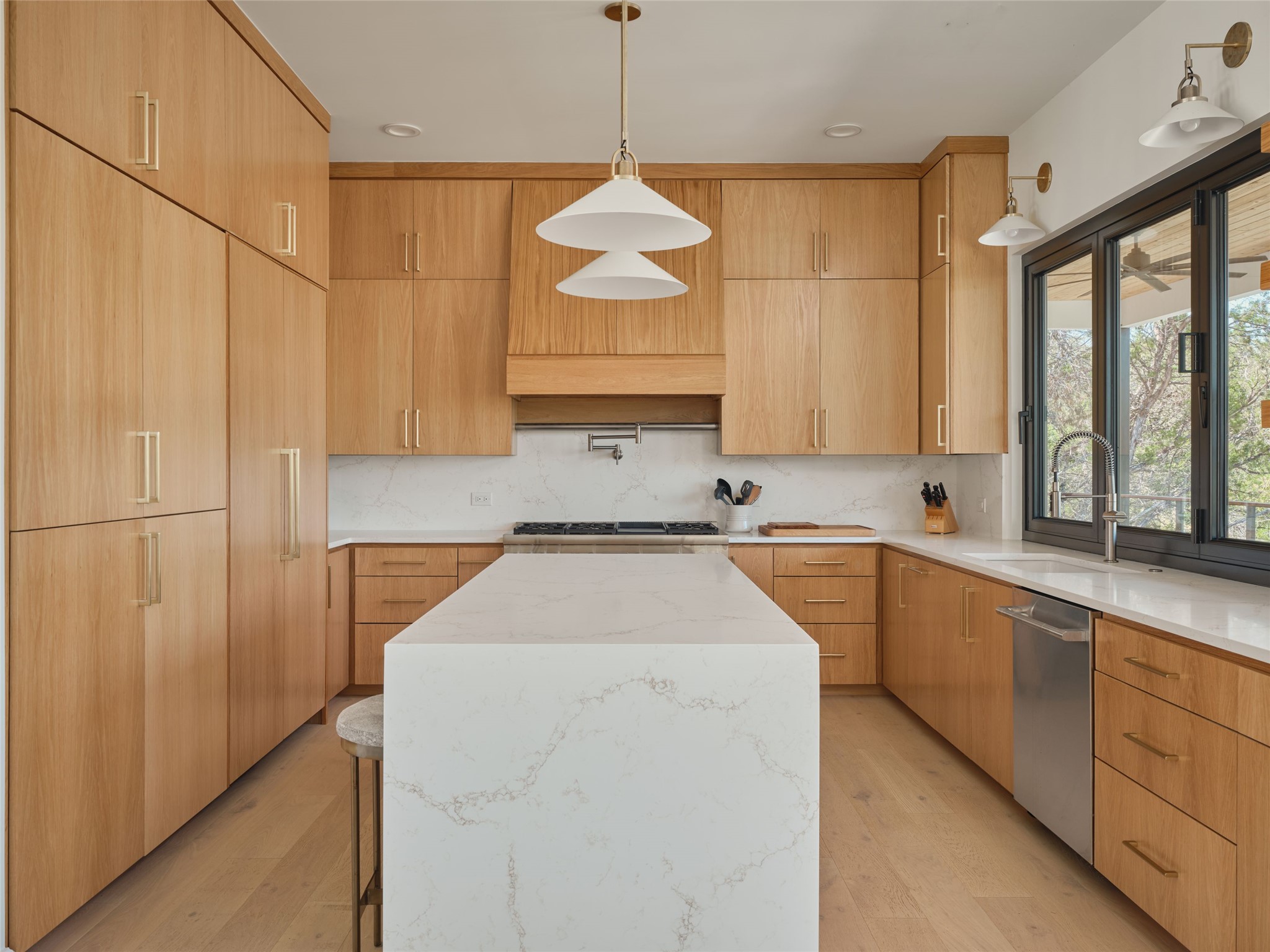 3214 Smoky Ridge, Unit LOT A Austin, TX 78730 - Photo 4 of 32 Kitchen with a center island, light stone countertops, modern cabinets, and tasteful backsplash