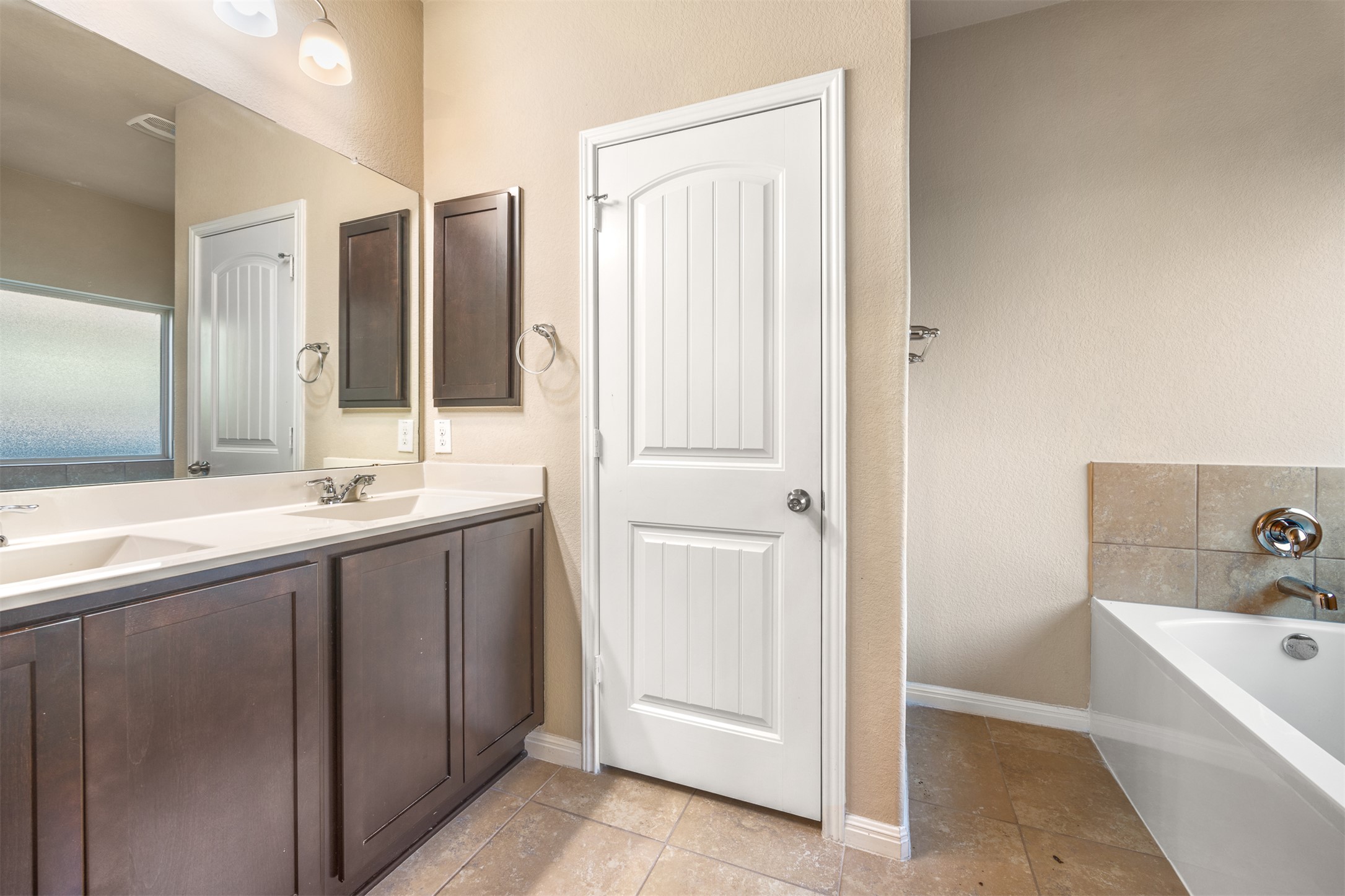 125 Serrano Street Georgetown, TX 78628 - Photo 11 of 18 a bathroom with a tub sink and mirror