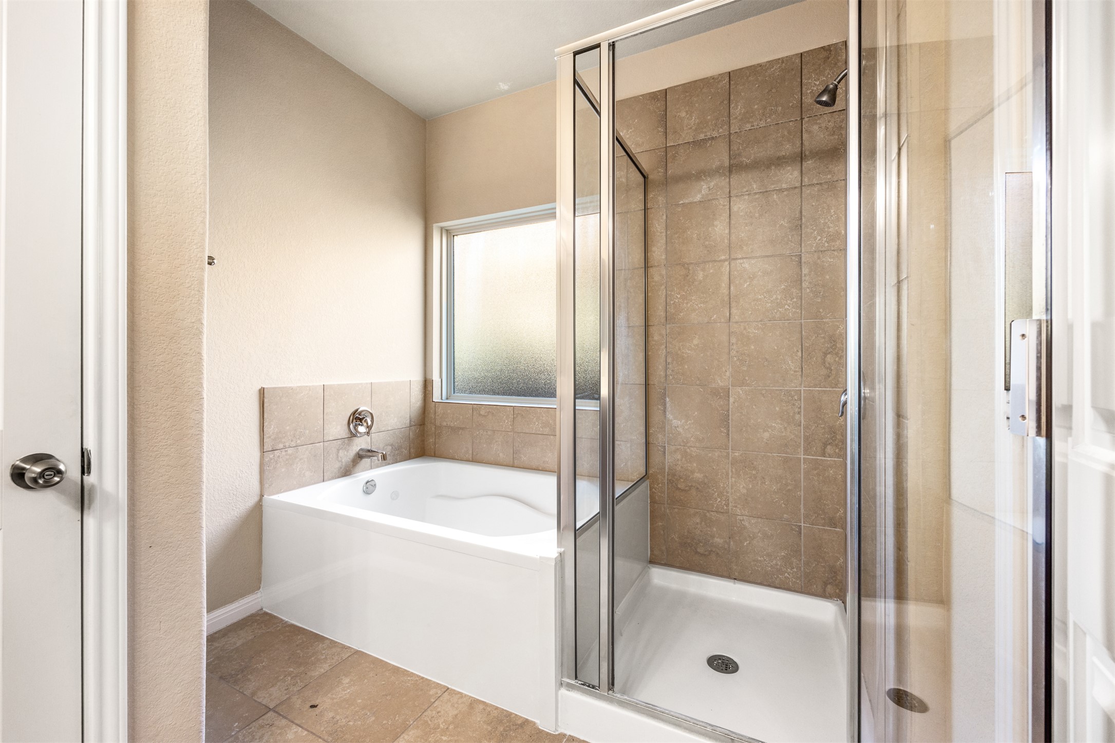 125 Serrano Street Georgetown, TX 78628 - Photo 12 of 18 a bathroom with a bathtub and a shower