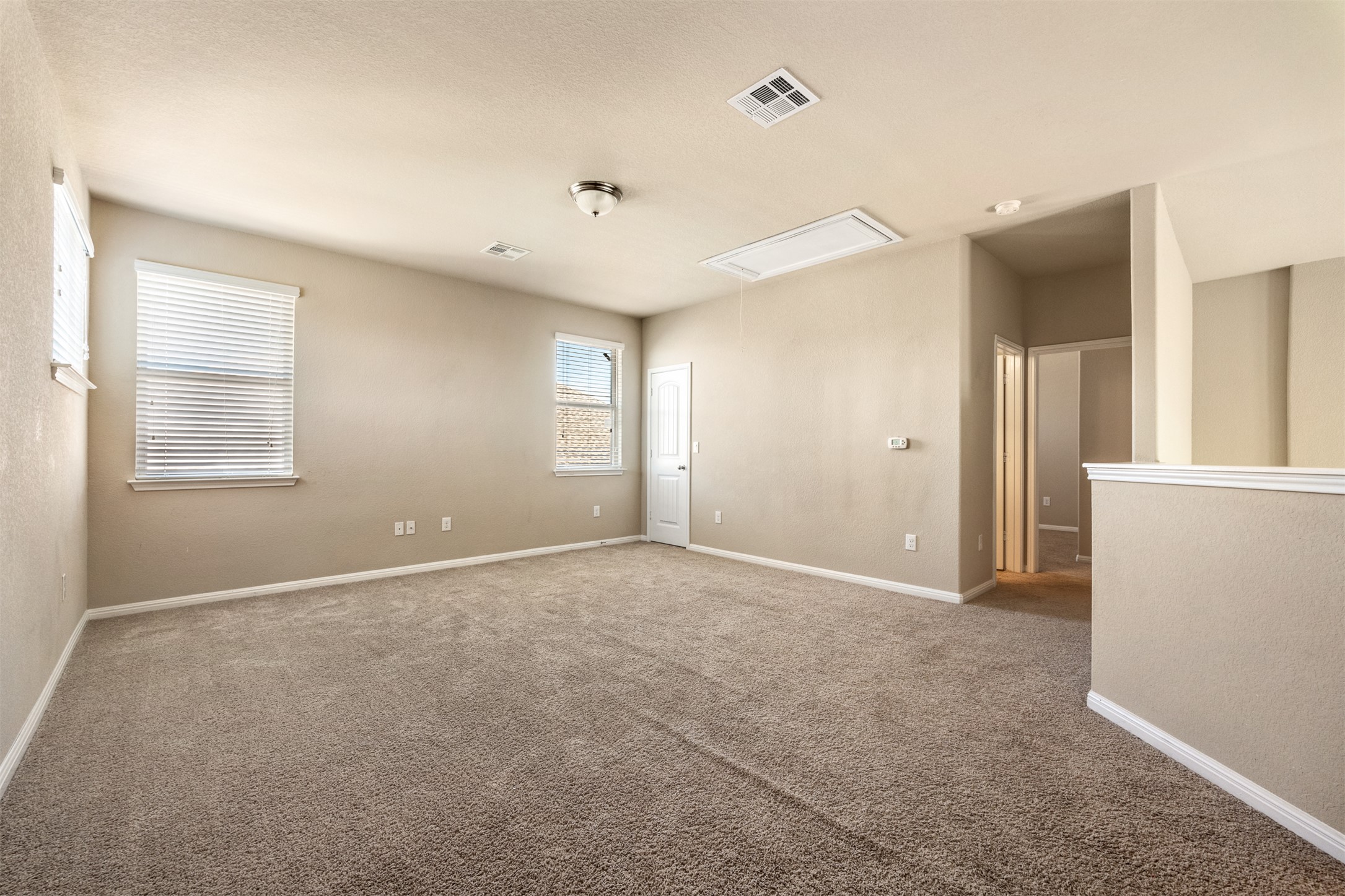 125 Serrano Street Georgetown, TX 78628 - Photo 13 of 18 an empty room with windows and closet
