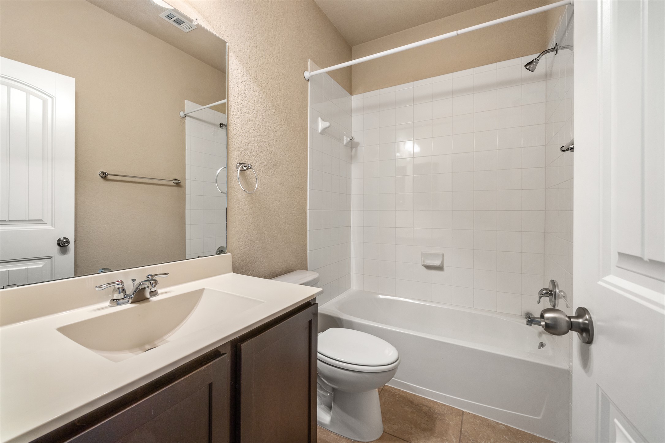 125 Serrano Street Georgetown, TX 78628 - Photo 14 of 18 a bathroom with a sink a toilet and a bathtub