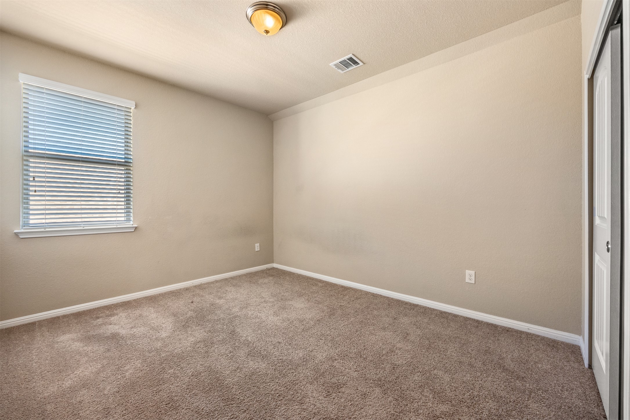 125 Serrano Street Georgetown, TX 78628 - Photo 15 of 18 an empty room with windows