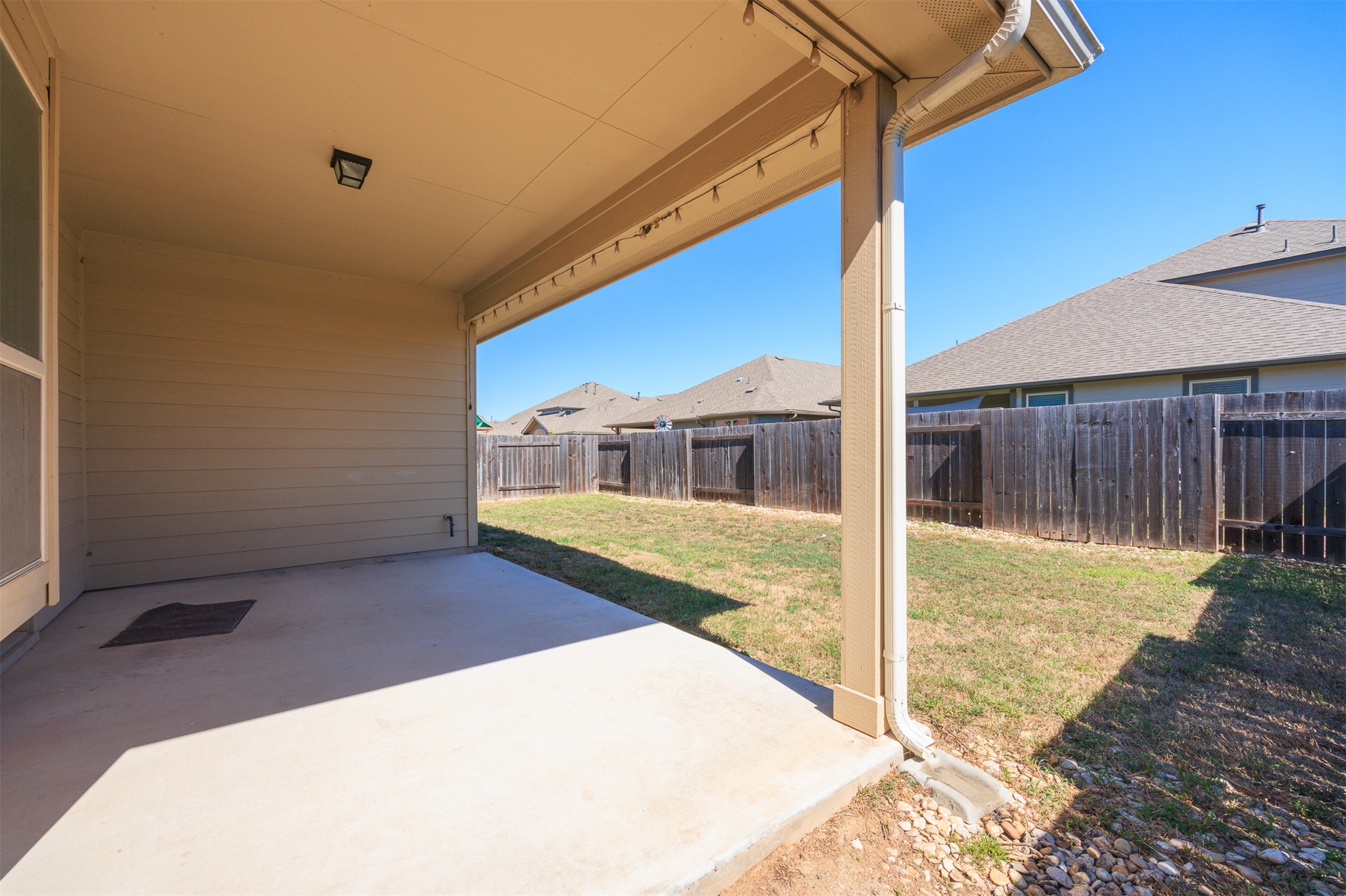 125 Serrano Street Georgetown, TX 78628 - Photo 16 of 18 a view of a house with backyard
