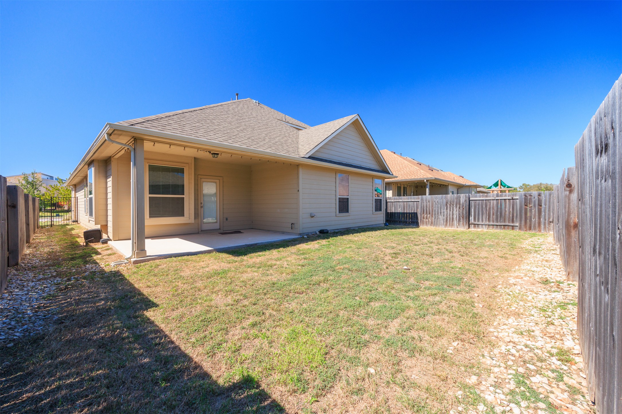 125 Serrano Street Georgetown, TX 78628 - Photo 17 of 18 a view of a house with a yard