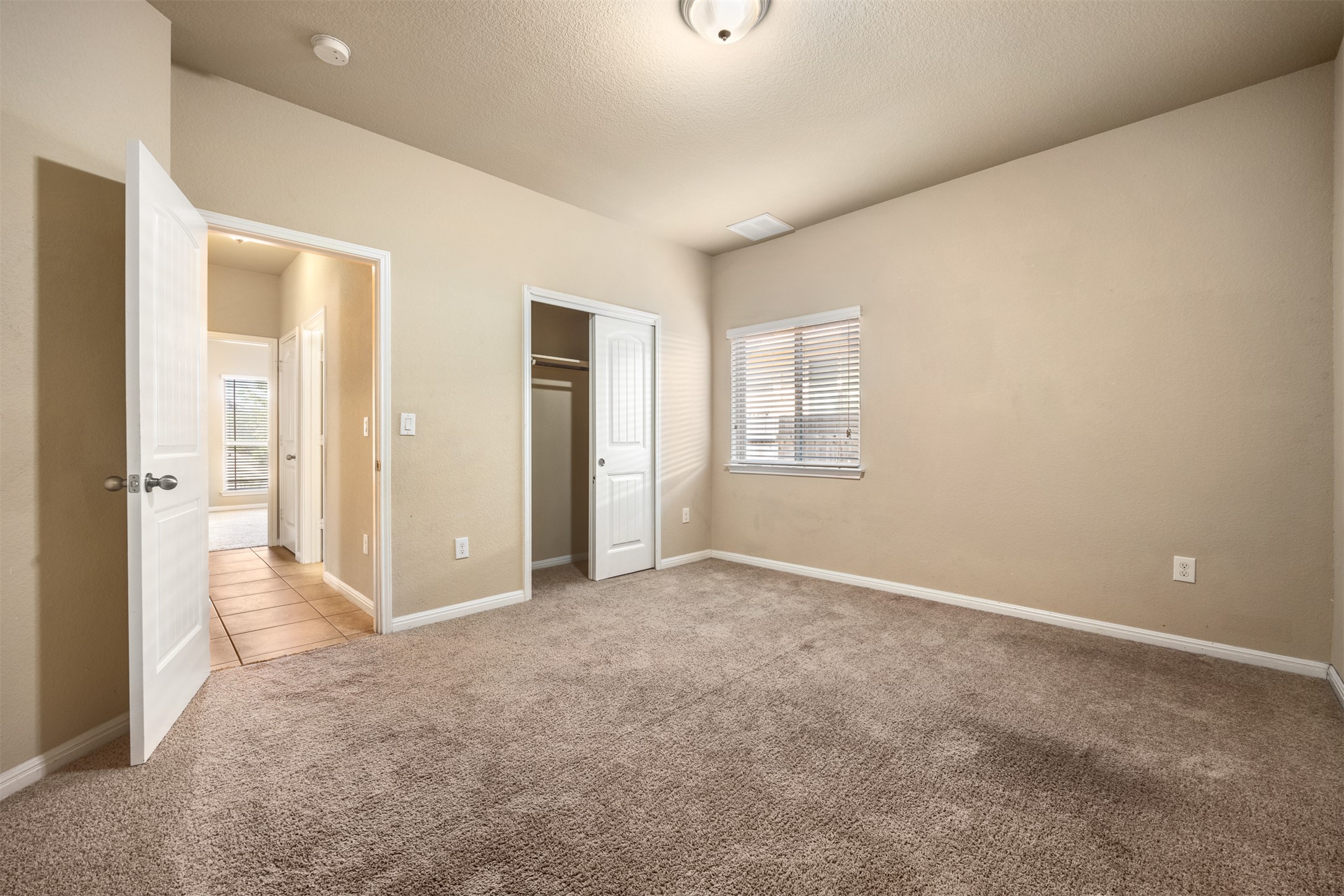 125 Serrano Street Georgetown, TX 78628 - Photo 7 of 18 an empty room with windows and closet
