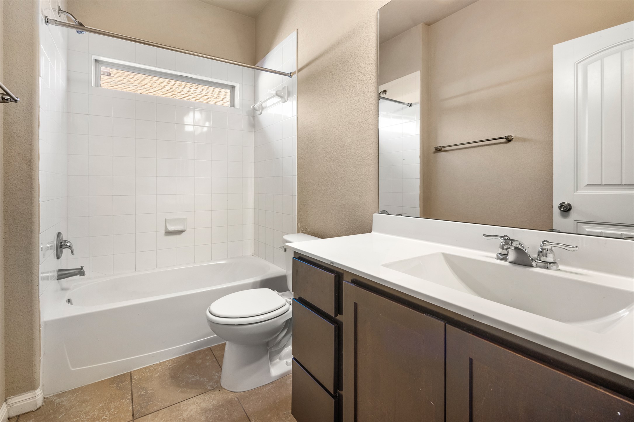 125 Serrano Street Georgetown, TX 78628 - Photo 8 of 18 a bathroom with a sink a toilet and a large mirror