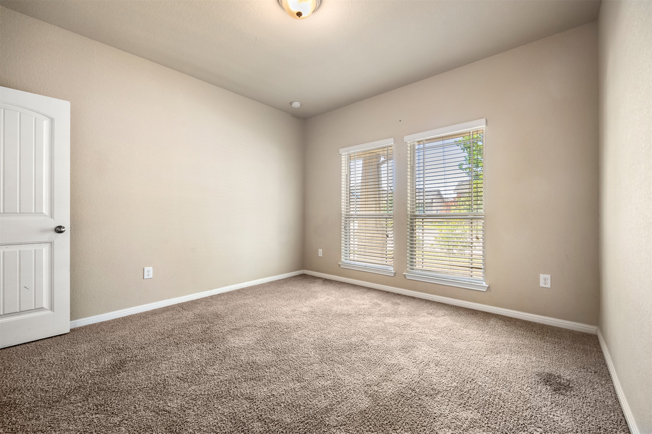 125 Serrano Street Georgetown, TX 78628 - Photo 9 of 18 an empty room with windows