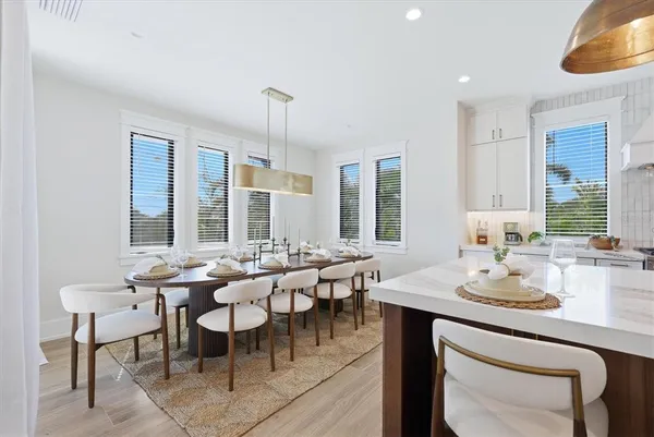 a kitchen with stainless steel appliances granite countertop a sink a stove and a wooden floors