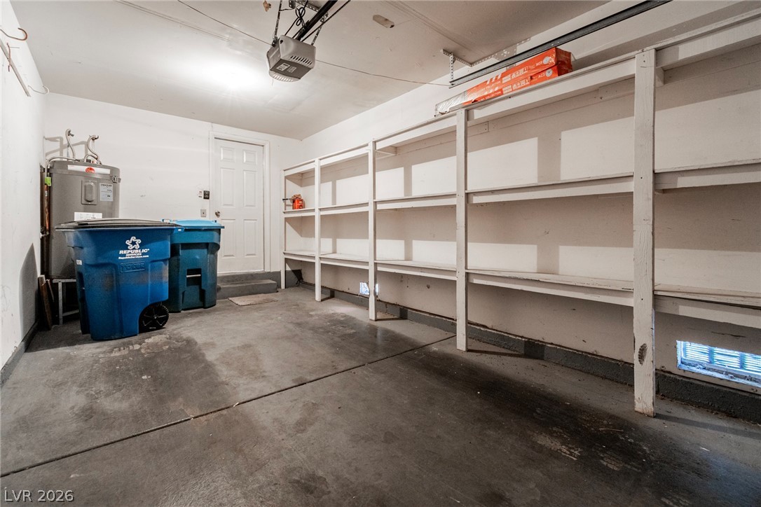 6250 West Flamingo Road, Unit 98 Las Vegas, NV 89103 - Photo 31 of 40 Garage featuring electric water heater and a garage door opener