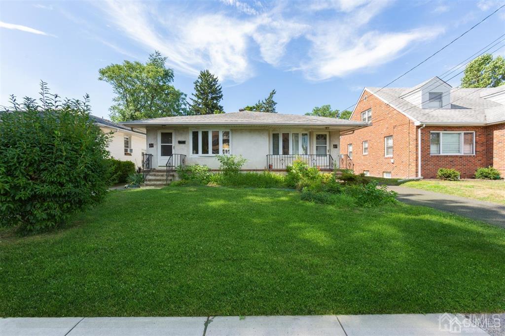 a front view of house with yard and green space