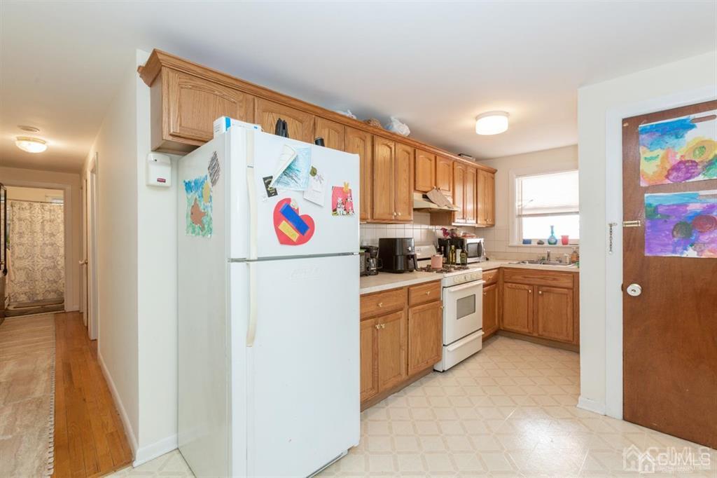 642 Front Street Dunellen, NJ 08812 - Photo 19 of 24 a kitchen with a refrigerator and a stove top oven