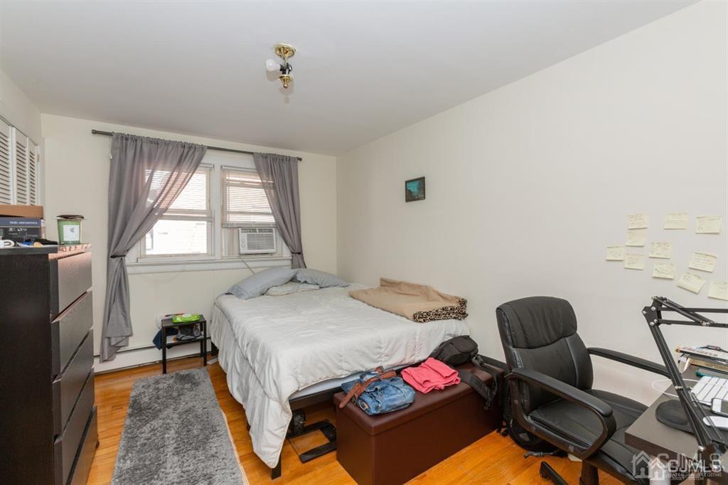 642 Front Street Dunellen, NJ 08812 - Photo 22 of 24 a bedroom with a bed and a chandelier
