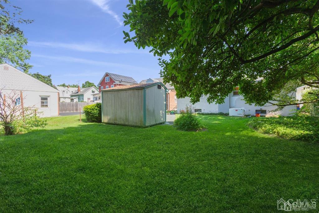 642 Front Street Dunellen, NJ 08812 - Photo 6 of 24 a view of a backyard with plants and large trees